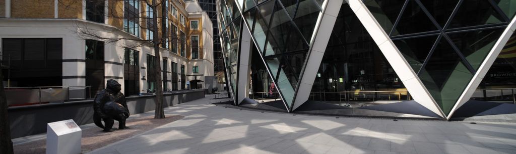 Image shows glass building in London with iconic gorilla statue to illustrate the work of laminated glass suppliers Kite Glass Weybridge