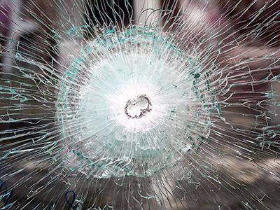 Bullet resistant glass manufacturers image of bulletproof glass that has been hit by a bullet and crazed but not broken