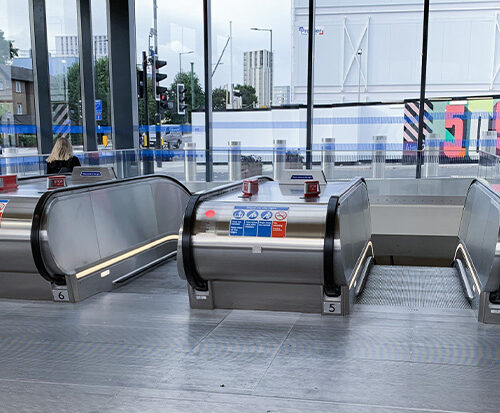 Escalators at Battersea Power Station Underground Station showing architectural glass