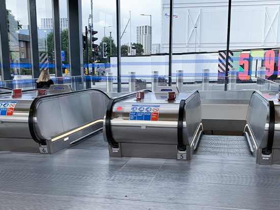 Escalators at Battersea Power Station Underground Station showing architectural glass